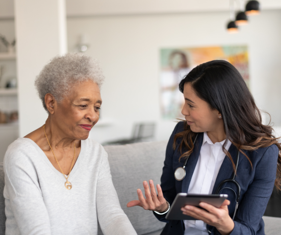 In-home physician discussing care plan with senior patient during home visit in West Palm Beach